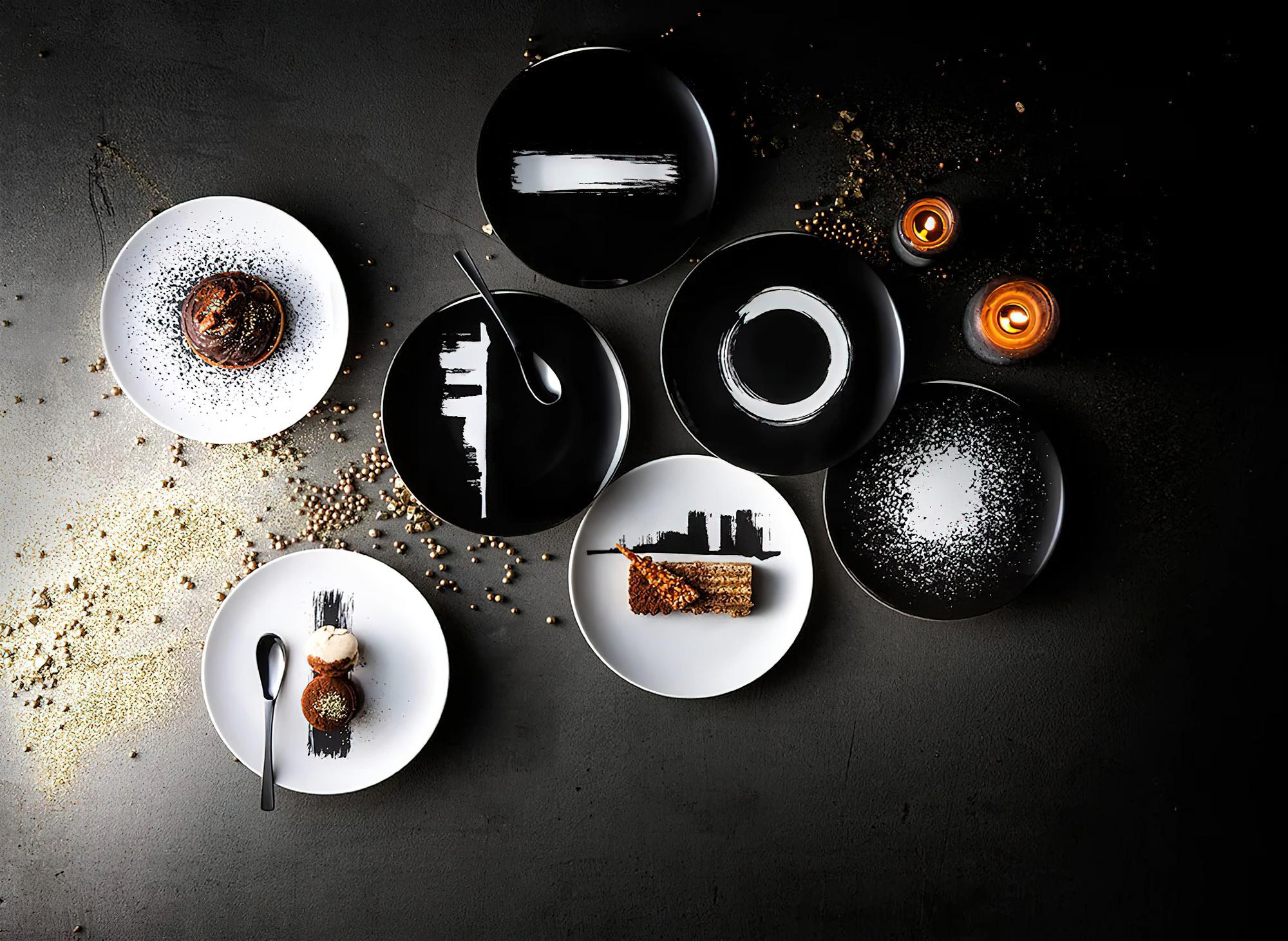 Arrangement of plated tasting menu on dark surface